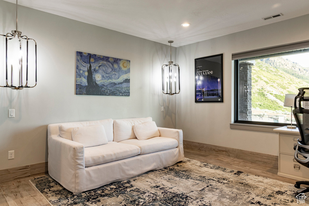 Living area with wood finished floors and recessed lighting