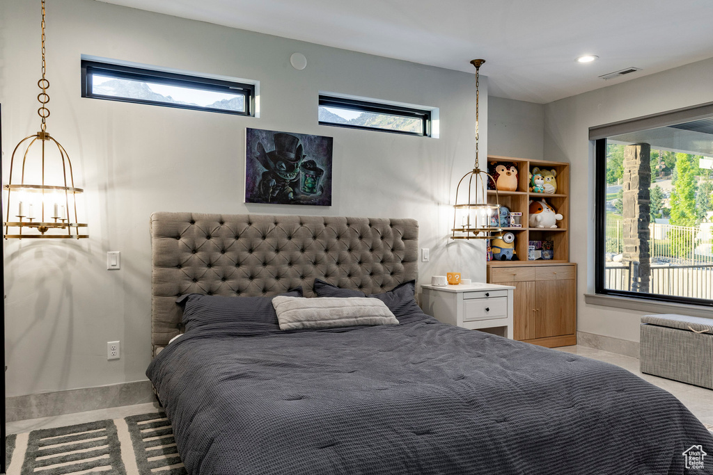 Bedroom with multiple windows and a chandelier