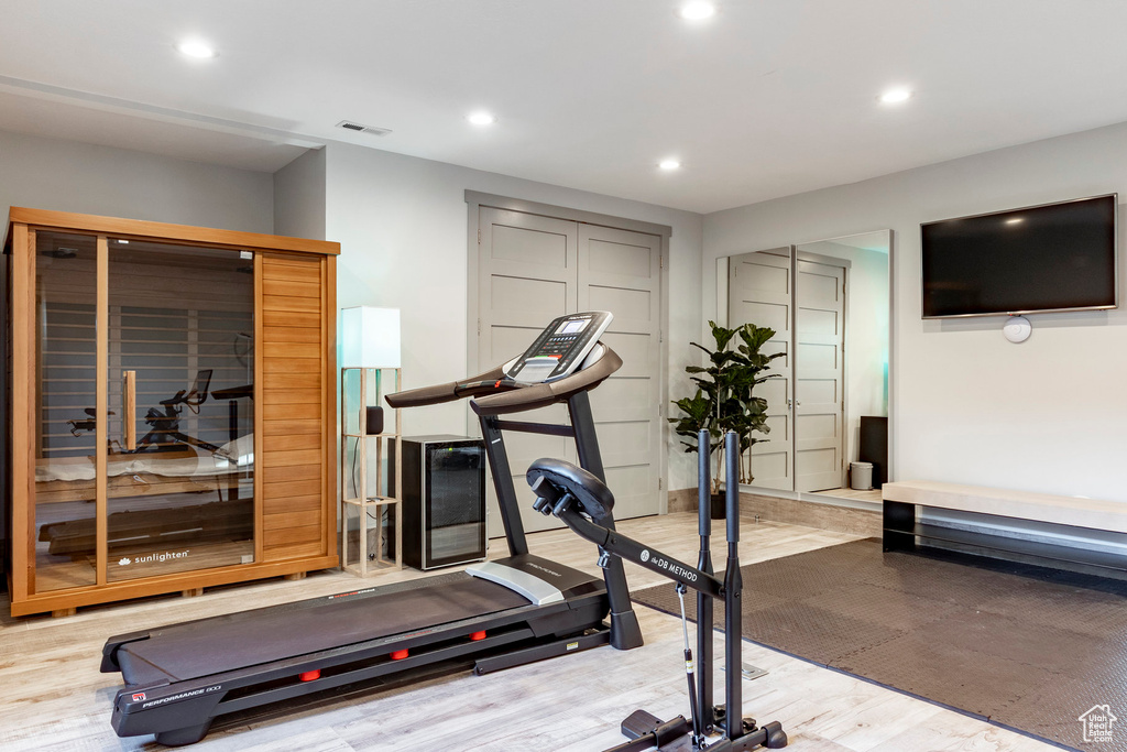 Workout room featuring recessed lighting and light wood-style flooring
