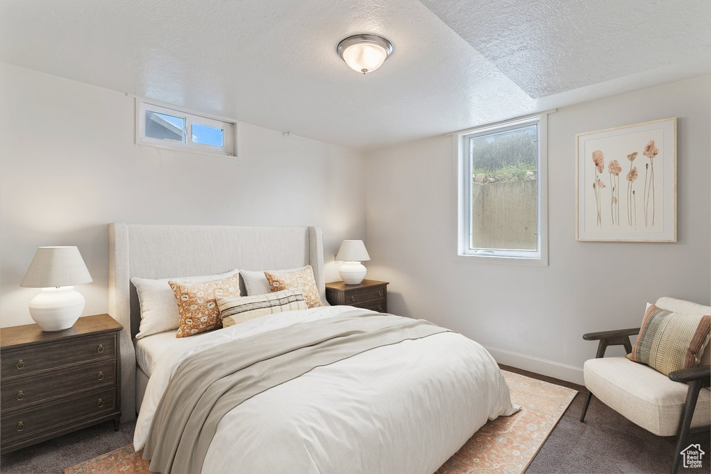 Bedroom featuring a textured ceiling and carpet