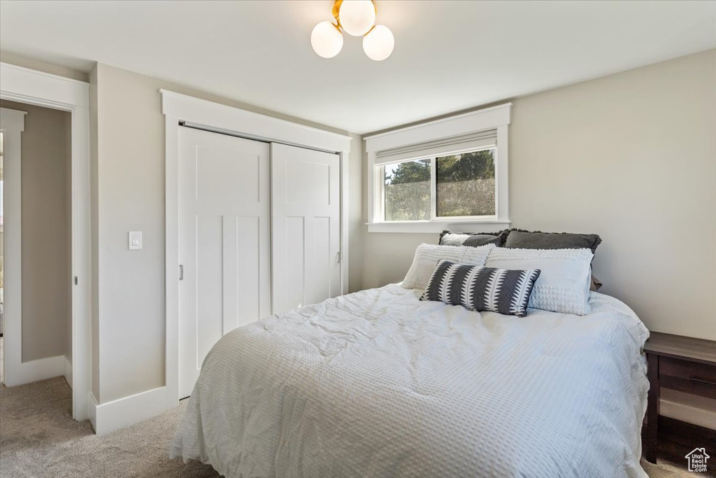 Bedroom with carpet and a closet
