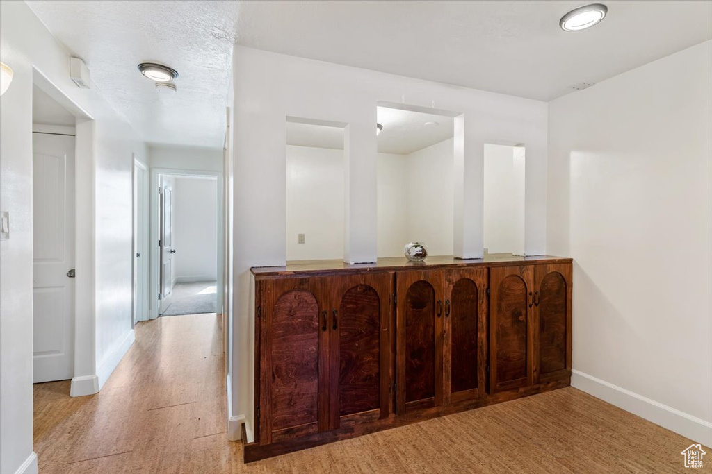 Bar featuring baseboards and light wood-style floors