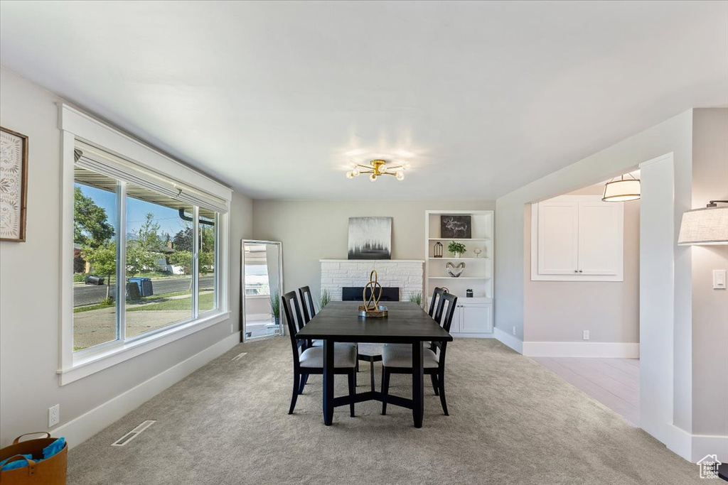 Dining room featuring light carpet and built in shelves