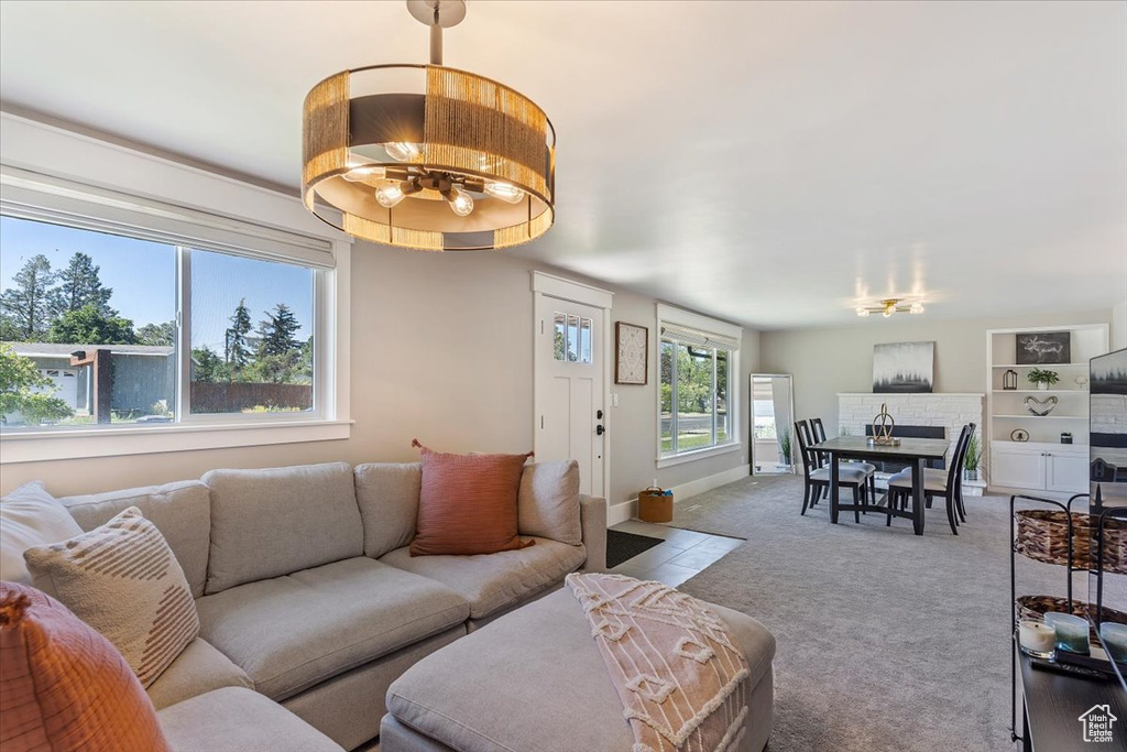 Living room featuring a chandelier and carpet