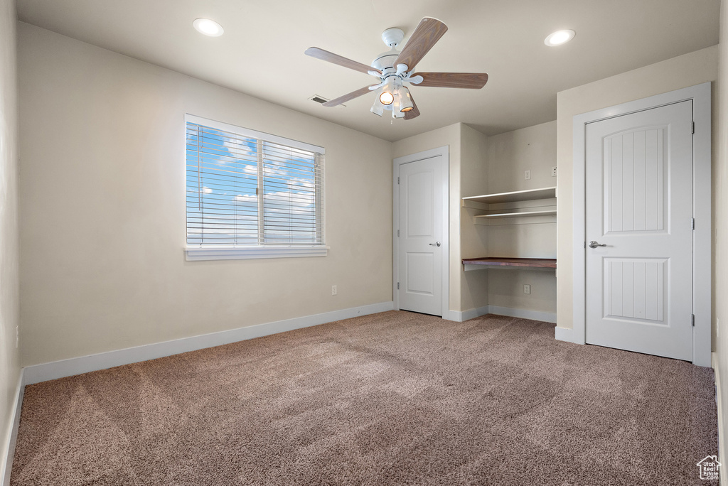 Unfurnished bedroom with carpet, recessed lighting, a closet, and ceiling fan