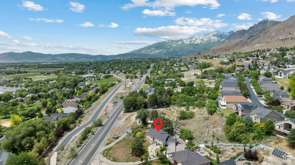 Aerial view of property's location featuring a mountainous background and nearby suburban area