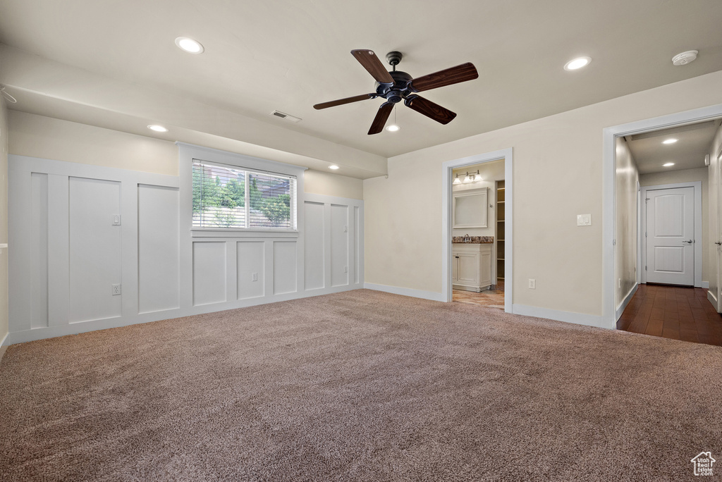 Unfurnished bedroom featuring carpet floors, recessed lighting, ensuite bathroom, a ceiling fan, and multiple closets