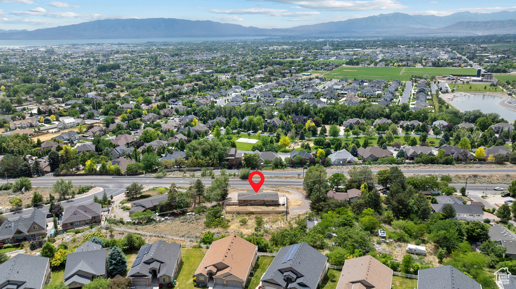 Aerial perspective of suburban area featuring a mountainous background