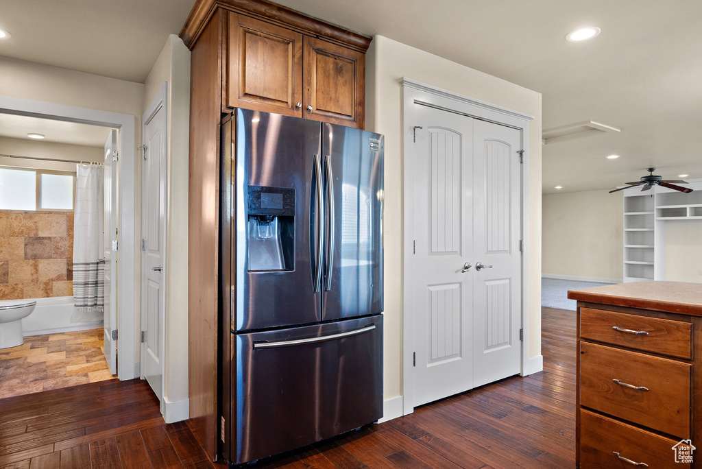 Kitchen with stainless steel refrigerator with ice dispenser, dark wood-style flooring, brown cabinets, recessed lighting, and ceiling fan