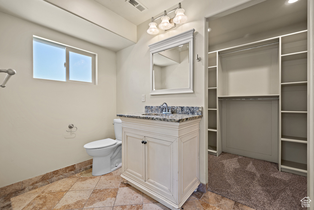 Bathroom with stone tile floors and vanity
