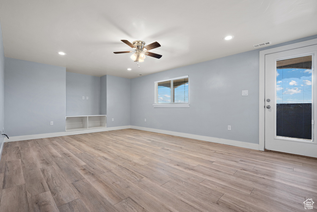 Spare room featuring a ceiling fan, light wood-style flooring, and recessed lighting