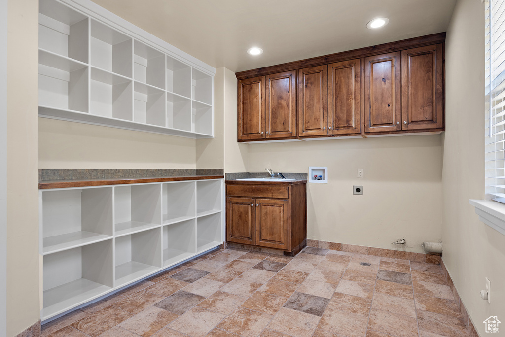 Laundry room with hookup for an electric dryer, cabinet space, light stone finish flooring, hookup for a washing machine, and recessed lighting