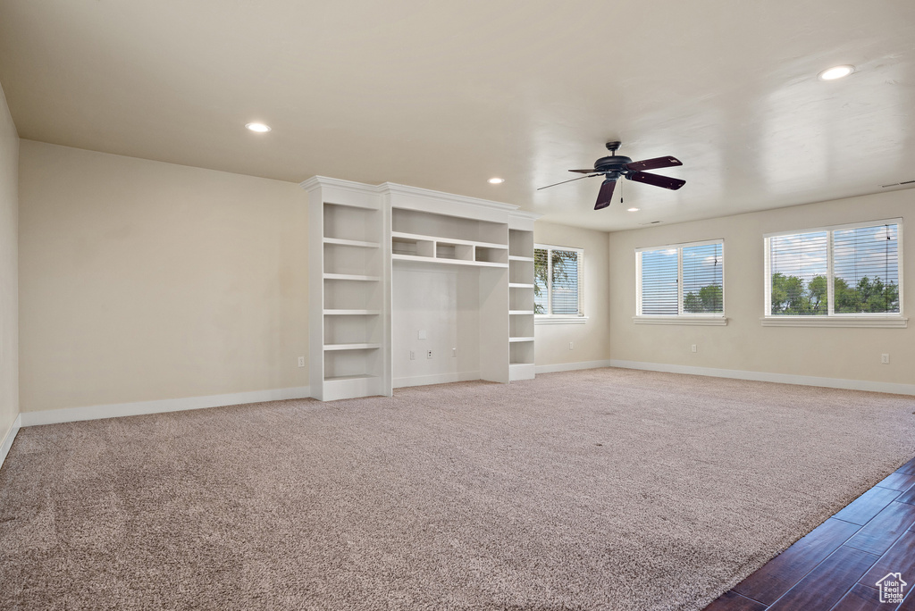 Unfurnished bedroom featuring recessed lighting, wood finished floors, a ceiling fan, carpet flooring, and a closet