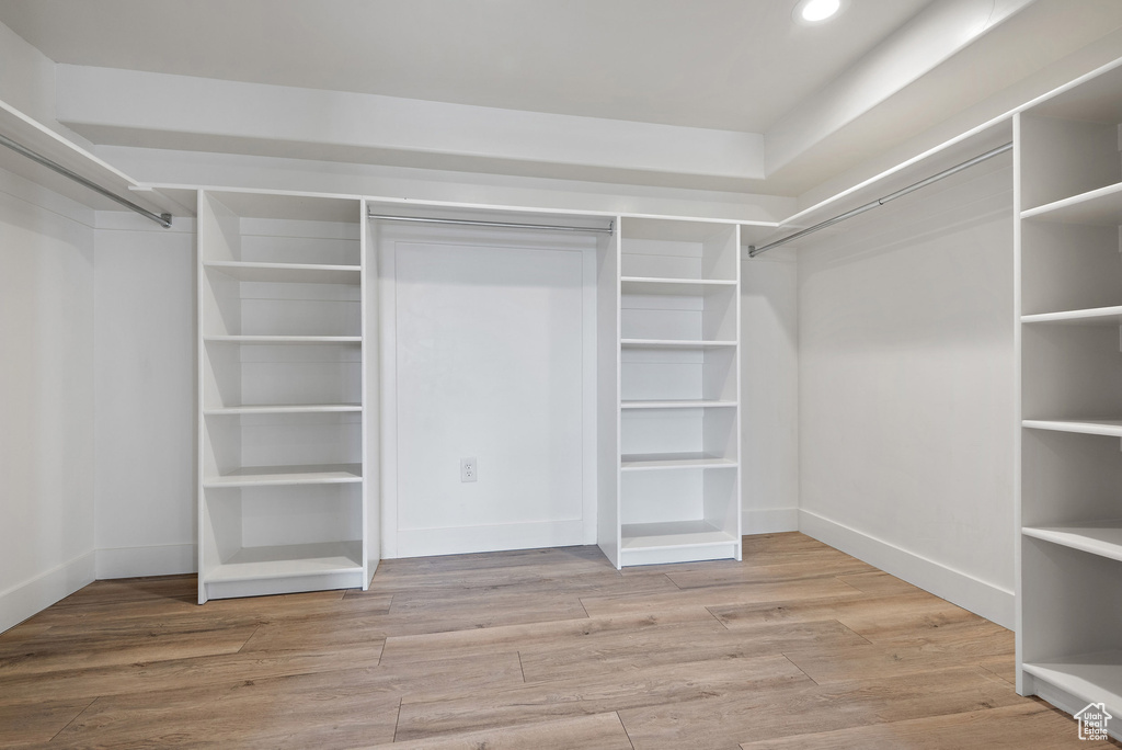 Walk in closet featuring wood finished floors