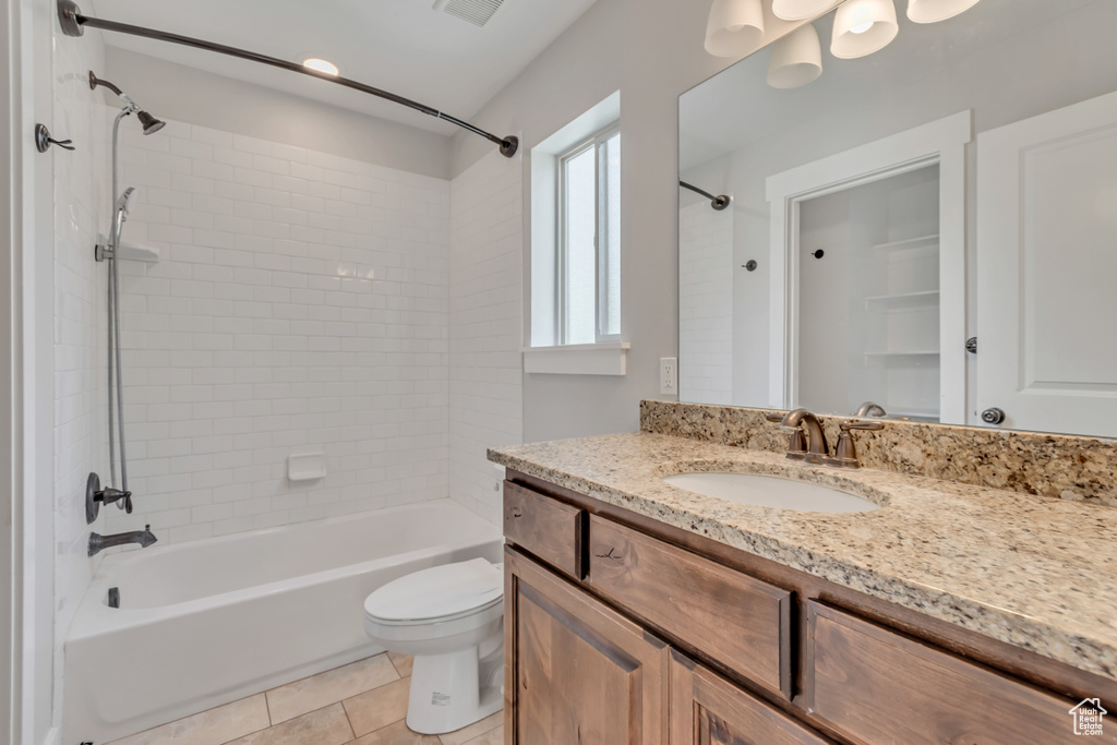 Bathroom with vanity, shower / washtub combination, and tile patterned flooring