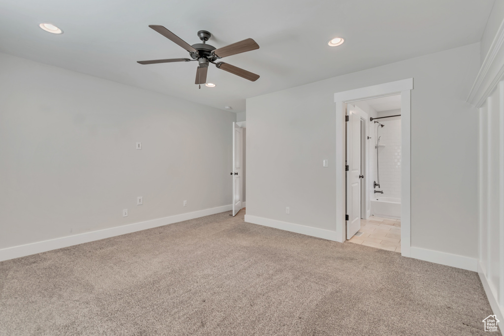 Unfurnished bedroom featuring light carpet, recessed lighting, ensuite bathroom, and a ceiling fan