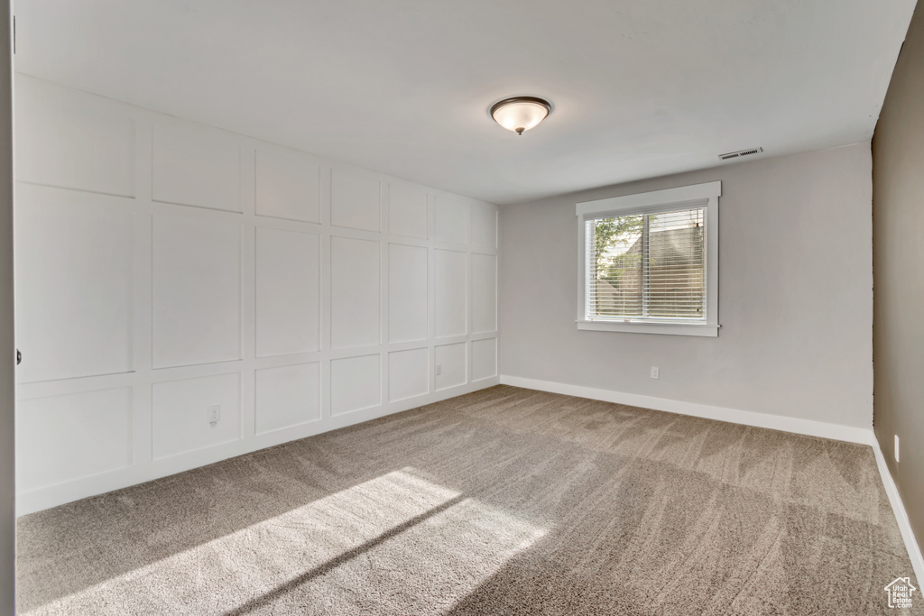 Carpeted empty room with baseboards
