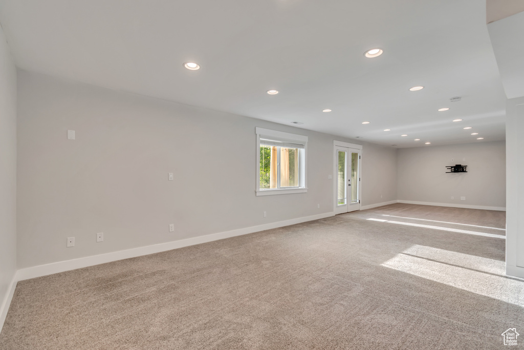 Empty room with recessed lighting and light carpet