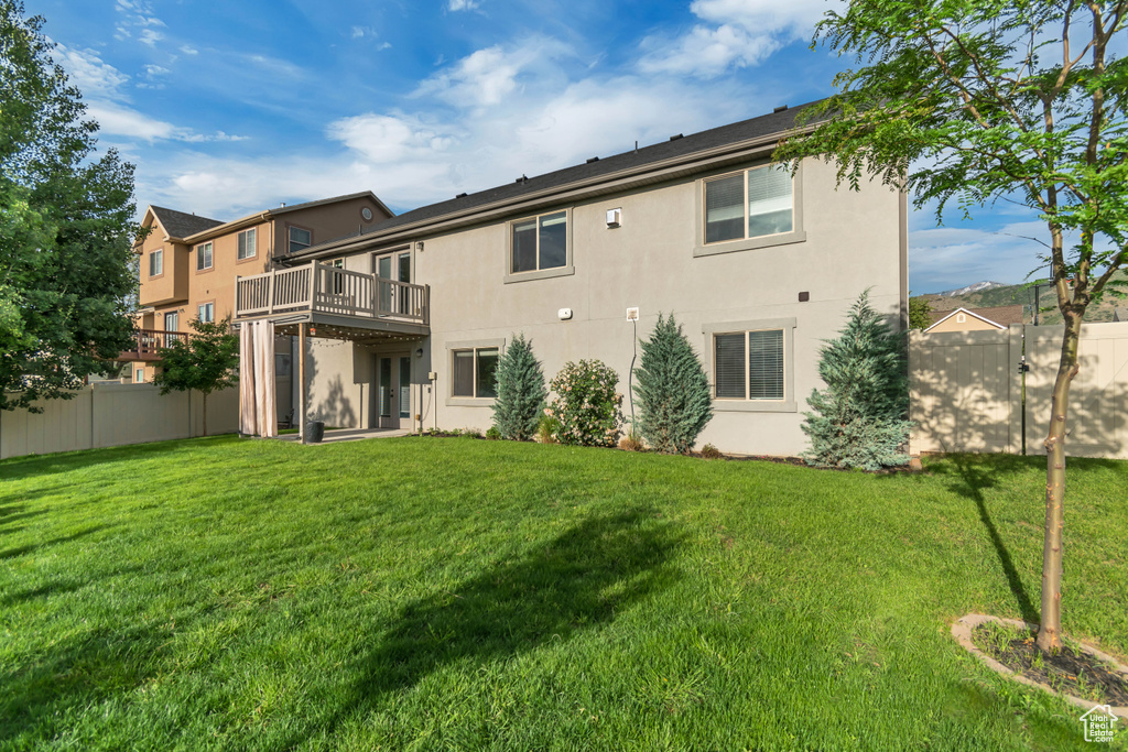 Back of property featuring stucco siding and a deck
