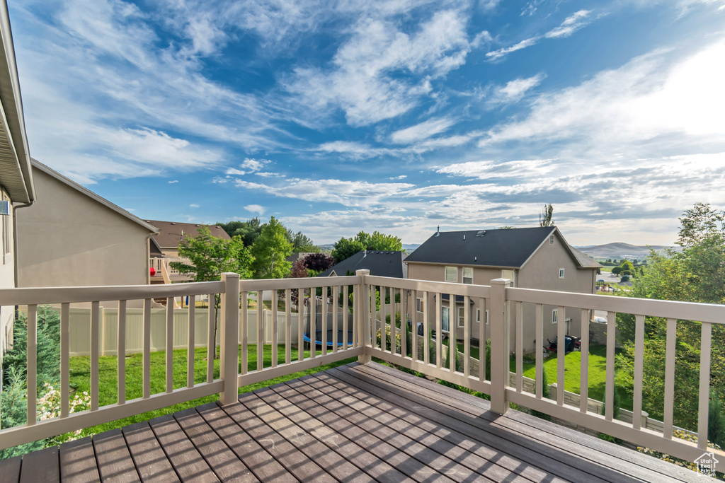 Wooden terrace featuring a residential view