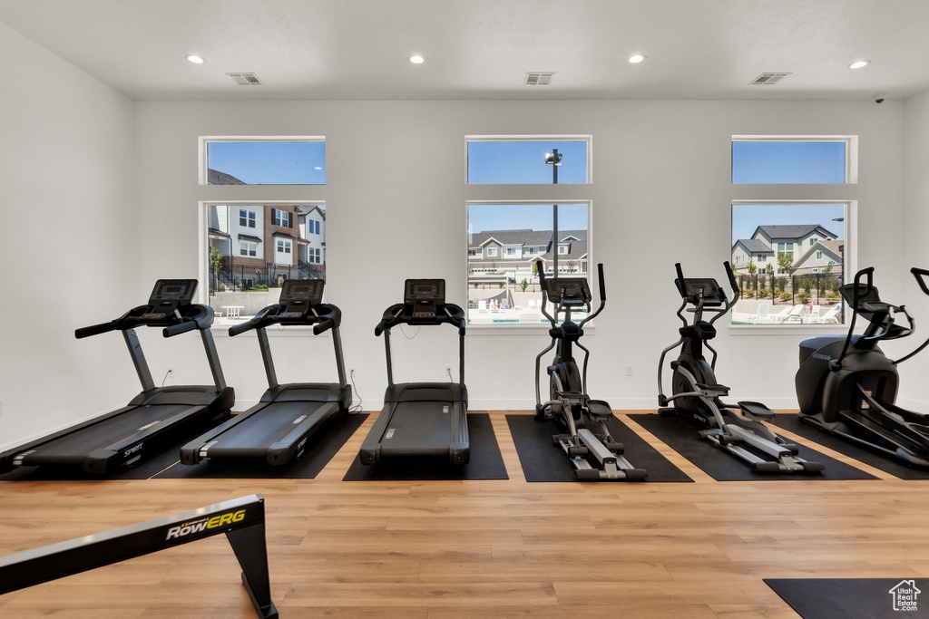 Exercise room featuring recessed lighting and wood finished floors