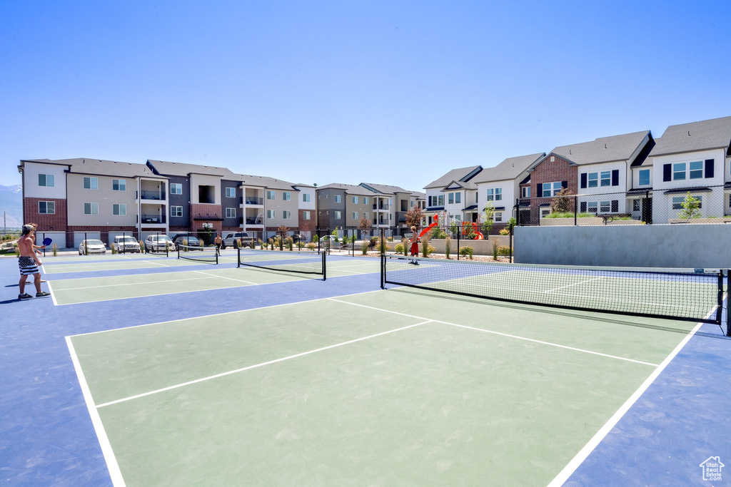 View of tennis court featuring a residential view and community basketball court