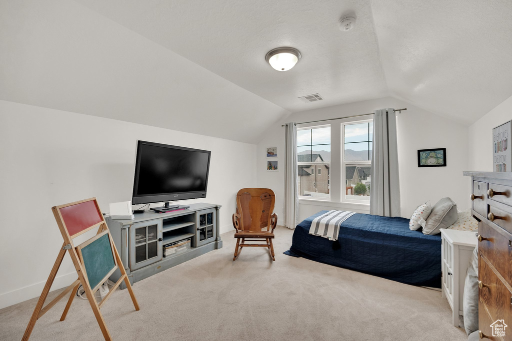 Bedroom featuring carpet and lofted ceiling