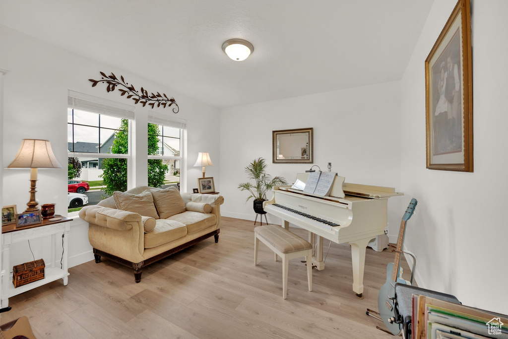 Living area featuring light wood-type flooring and baseboards