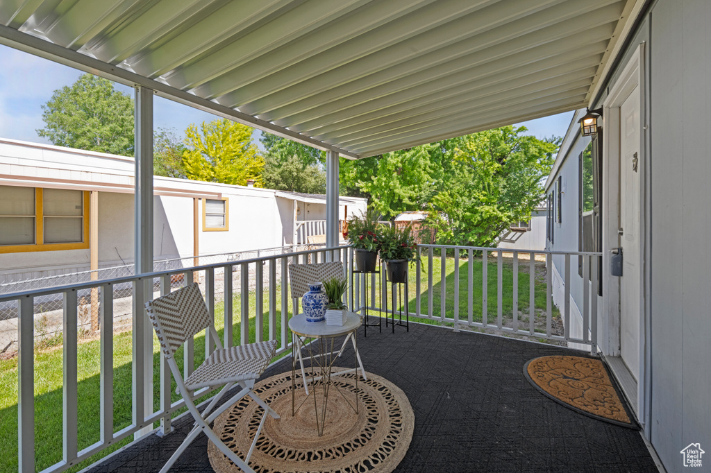 View of patio featuring a balcony