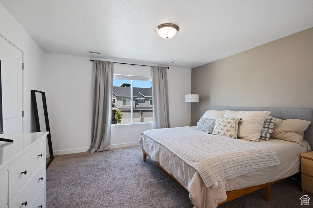 Bedroom featuring carpet floors and baseboards