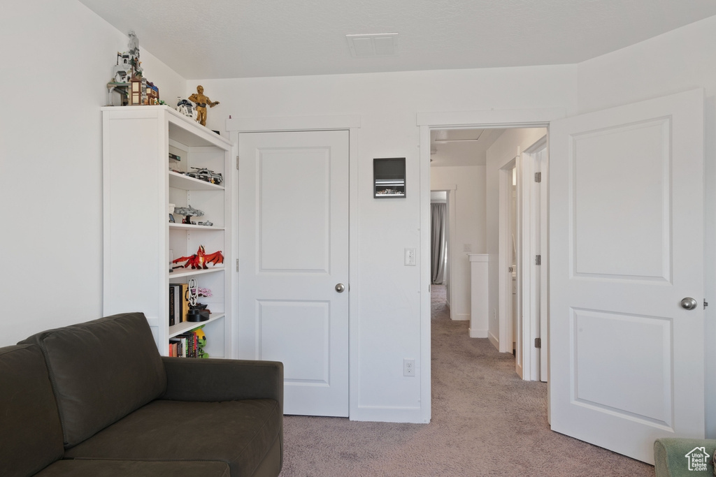 Sitting room with light colored carpet