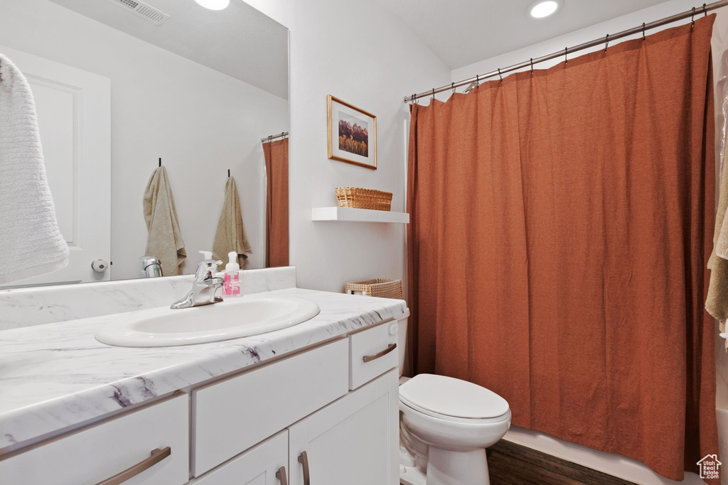 Full bath featuring vanity and recessed lighting
