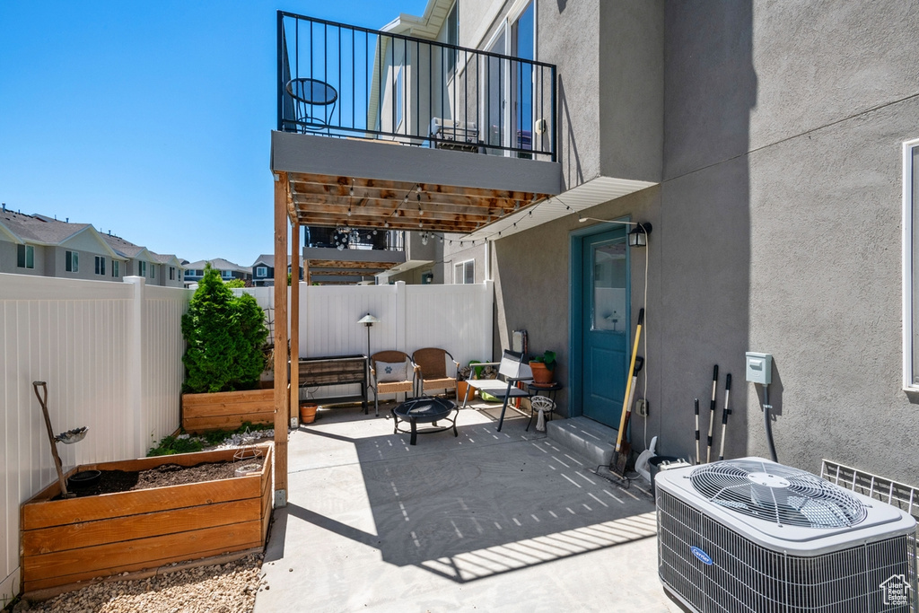 Patio / terrace with a fenced backyard, a patio area, and a vegetable garden