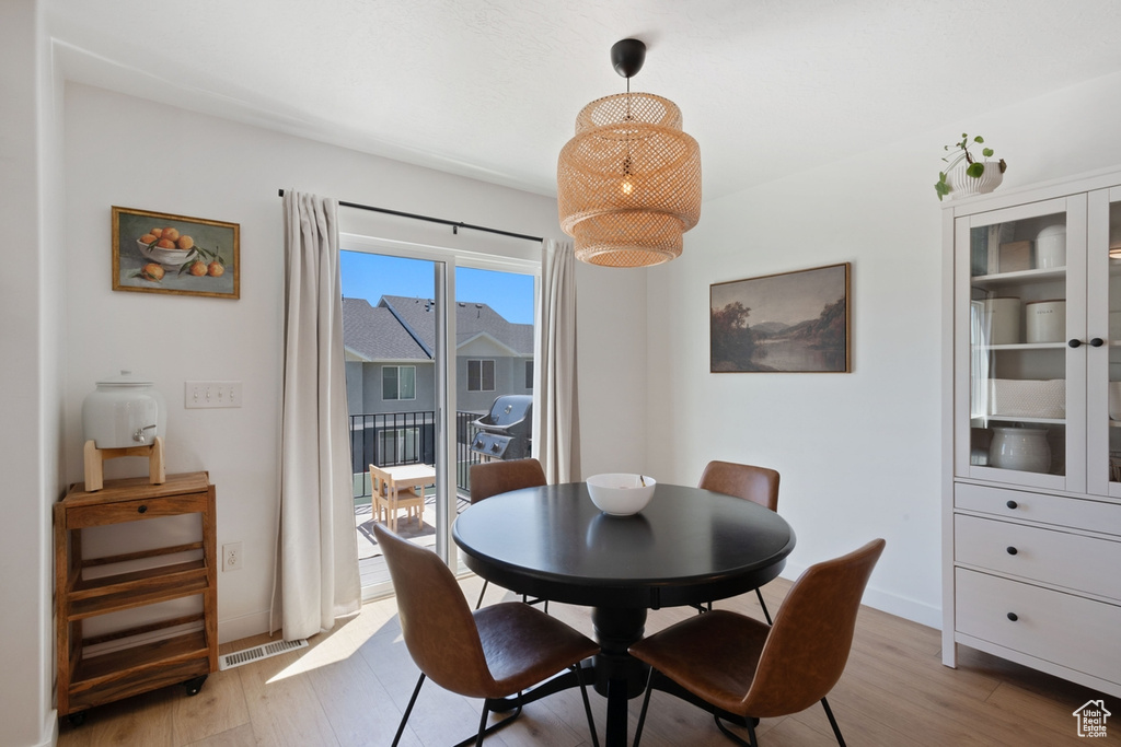 Dining area featuring light wood-style flooring and baseboards