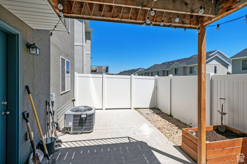 Fenced backyard with a patio area and a residential view