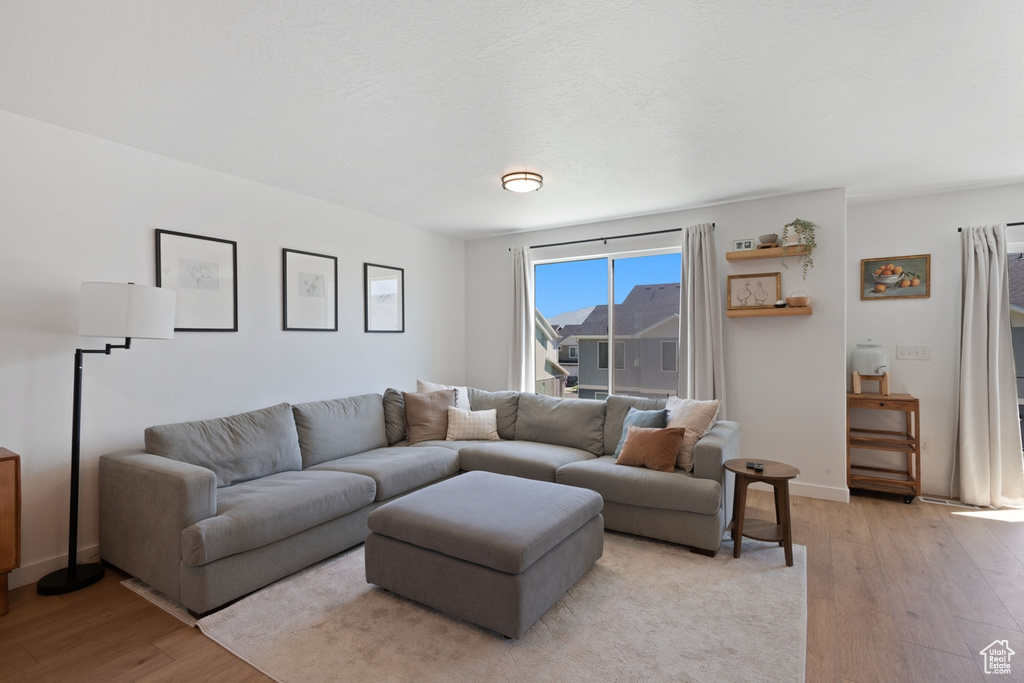 Living area with light wood-style floors and baseboards