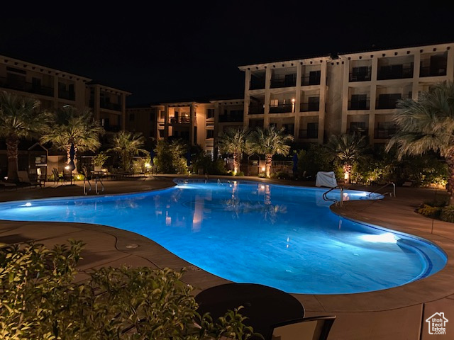 Pool at twilight with a community pool and a patio area