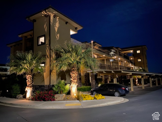 Property at twilight with covered parking