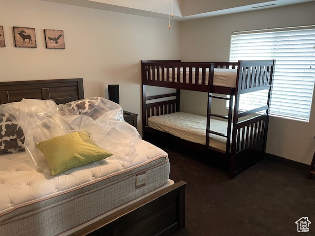 Bedroom with carpet floors and baseboards