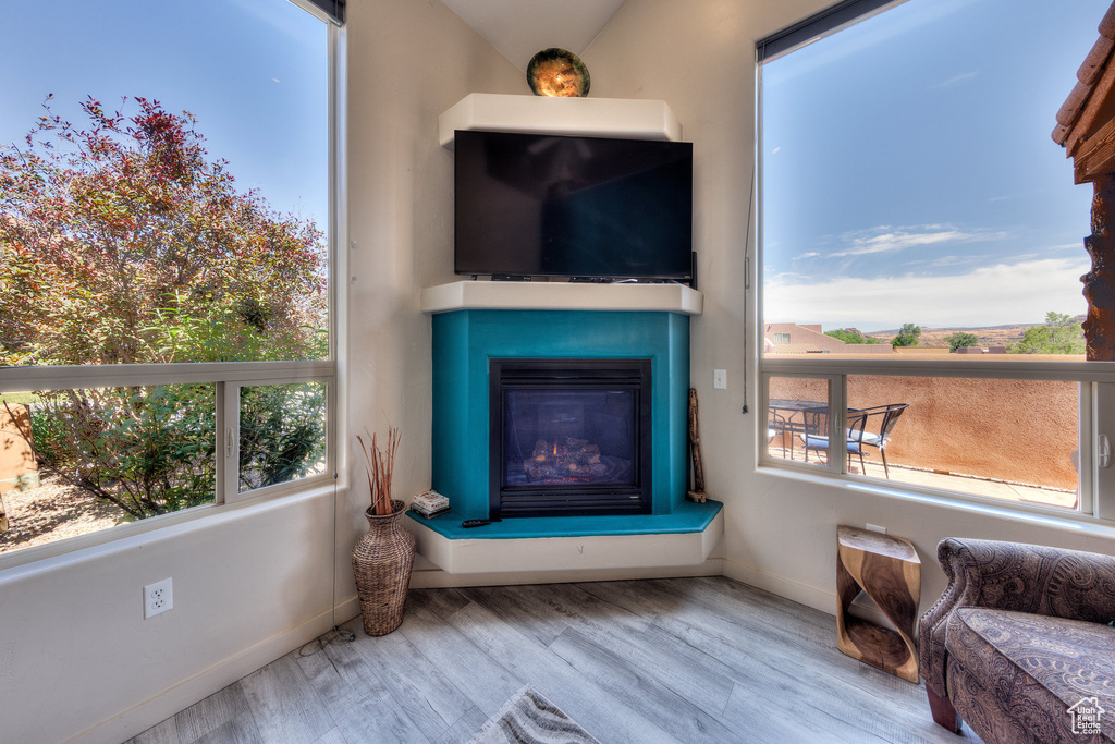 Sitting room featuring plenty of natural light, wood finished floors, and baseboards