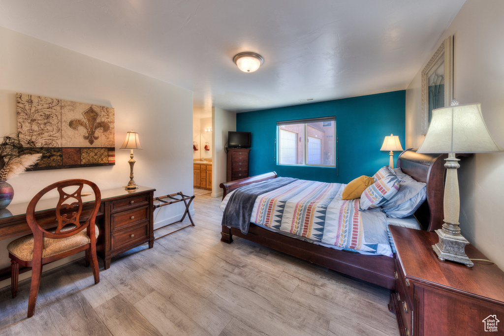 Bedroom with wood finished floors and ensuite bathroom