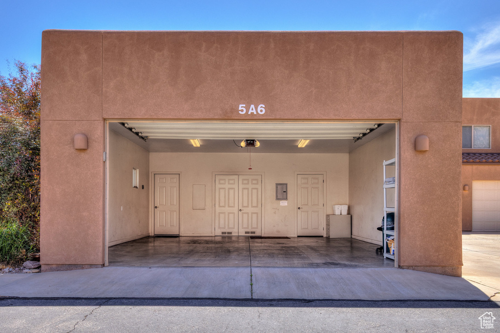 Garage featuring a garage door opener and electric panel