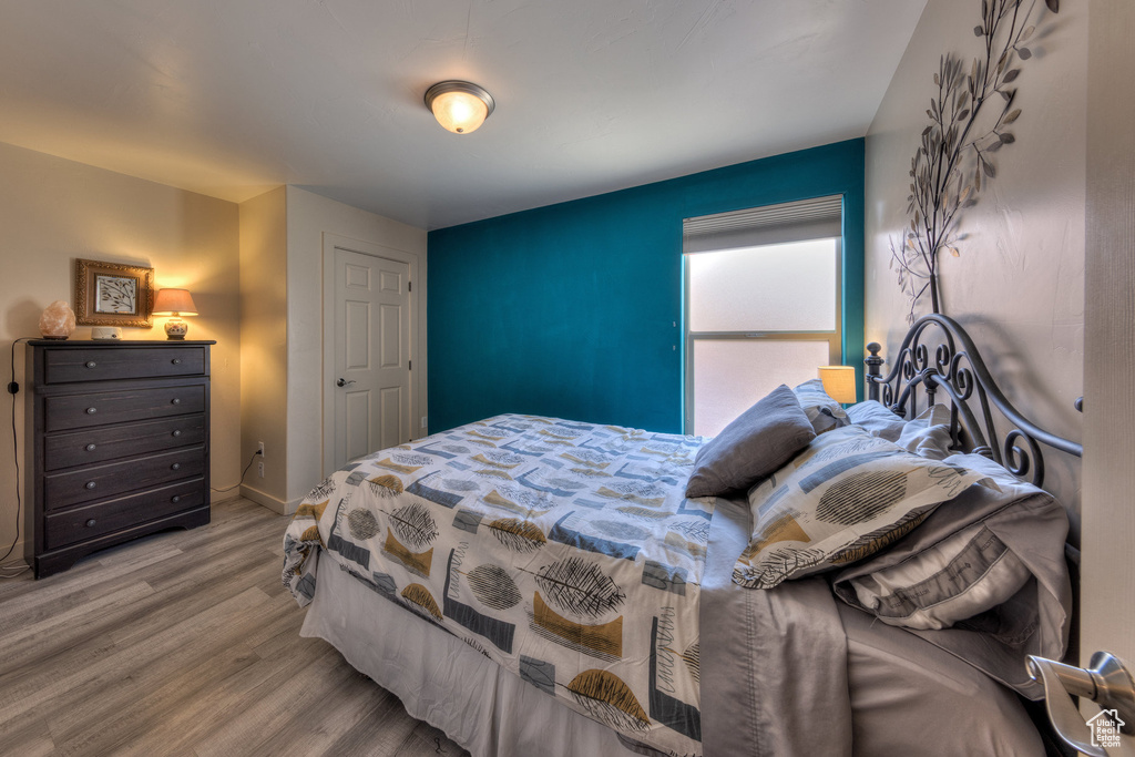 Bedroom featuring wood finished floors and baseboards