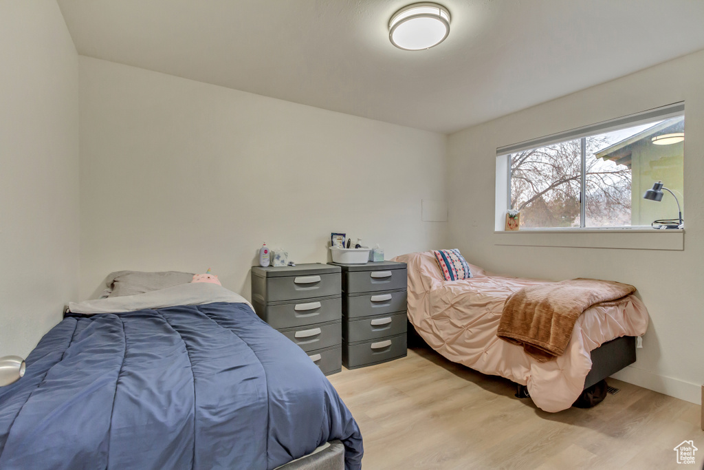 Bedroom with light wood-style flooring and baseboards