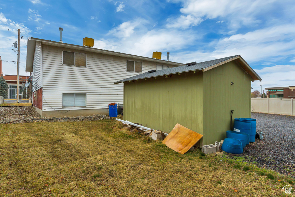 Rear view of property with a storage shed