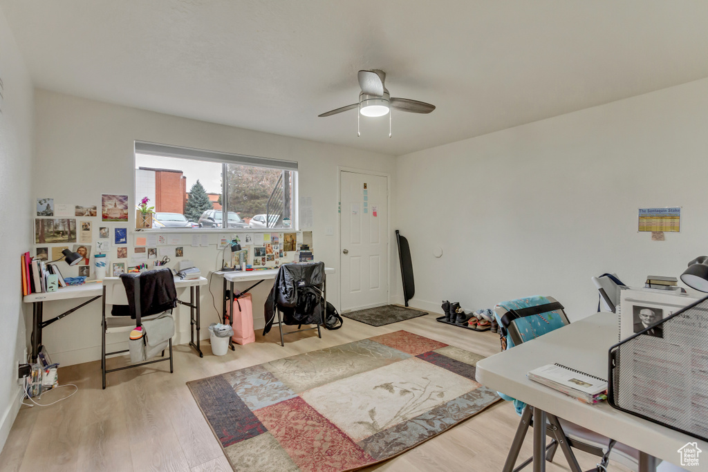 Office space with wood finished floors and a ceiling fan