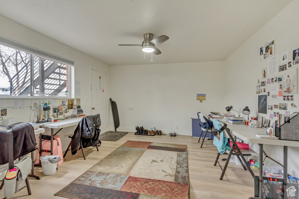 Office space with a ceiling fan and wood finished floors