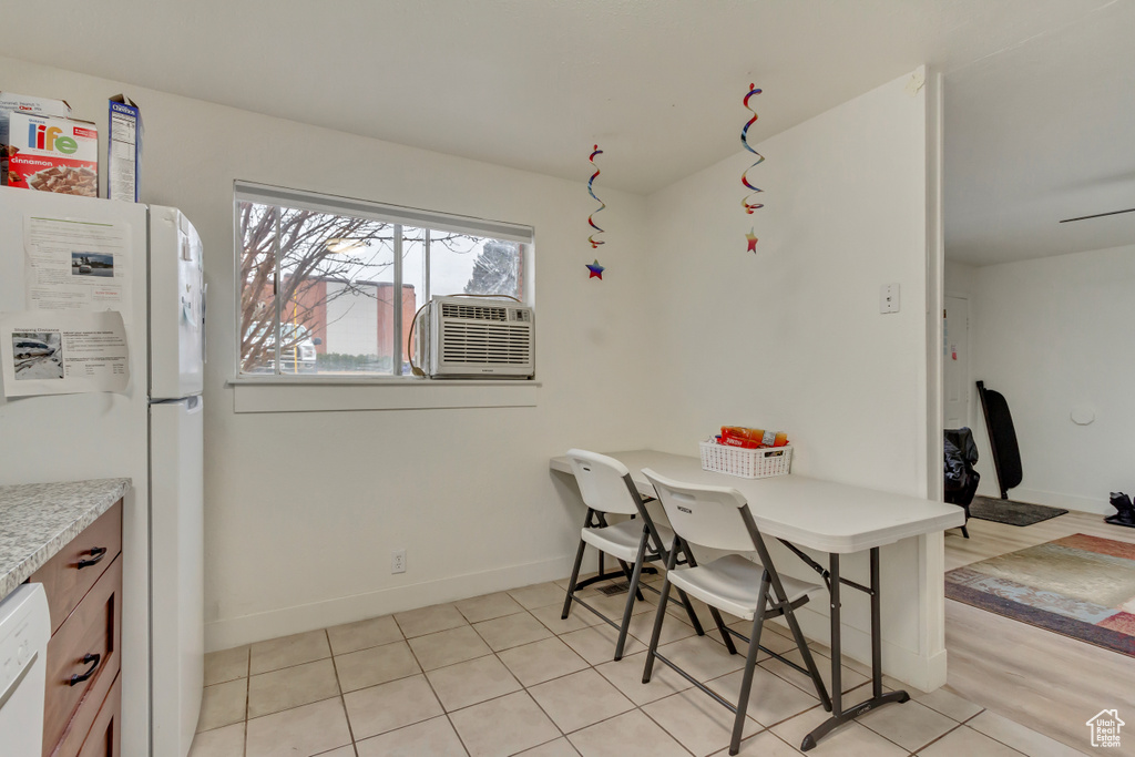 Dining room with light tile patterned flooring and cooling unit