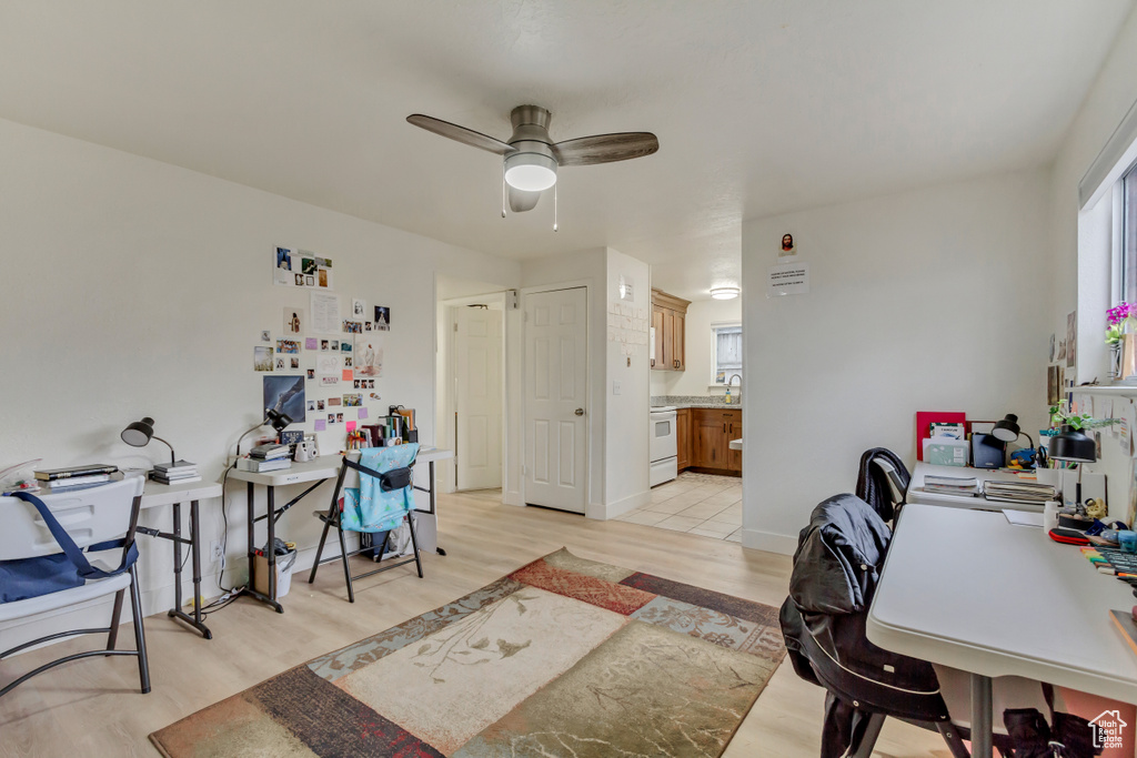 Office area featuring light wood-style flooring and a ceiling fan