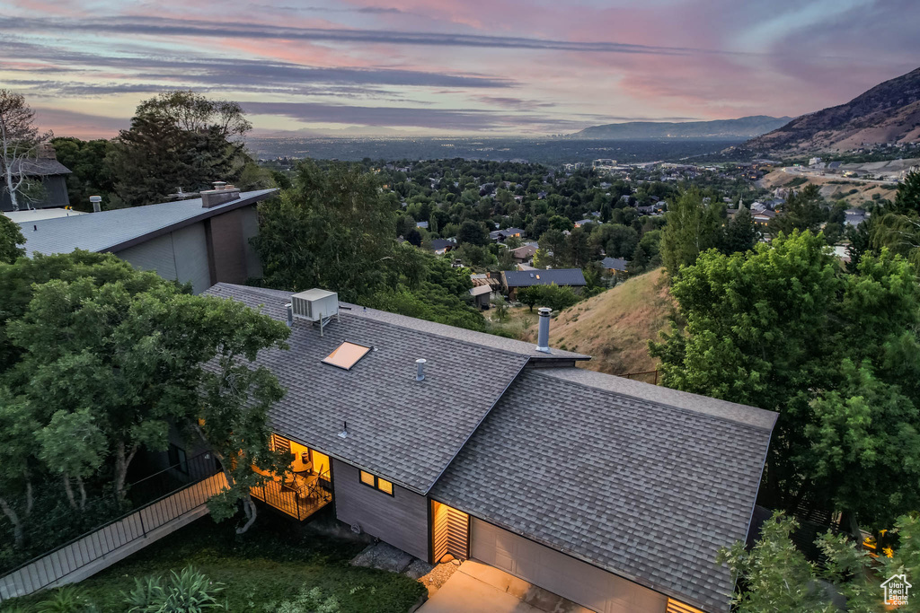 Aerial view of property and surrounding area with a mountain backdrop